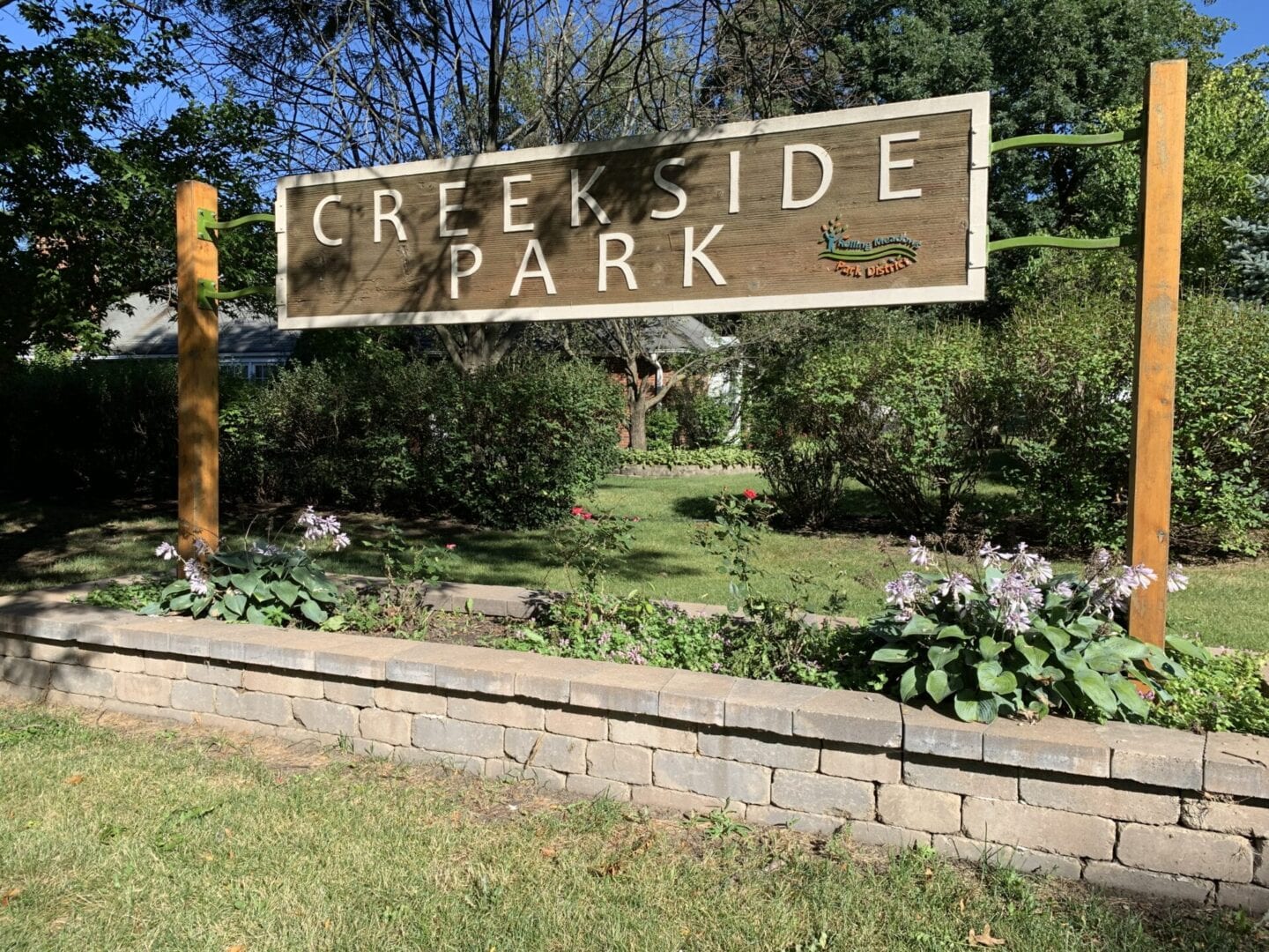 The name “Creekside Associations” engraved on a wooden plaque