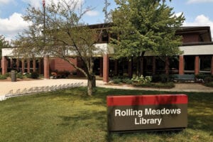 The front of a Rolling Meadows Library with a tree in front